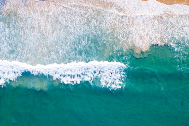 Aerial view sandy beach and waves Beautiful tropical sea in the morning summer season image by Aerial view drone shot, high angle view Top down