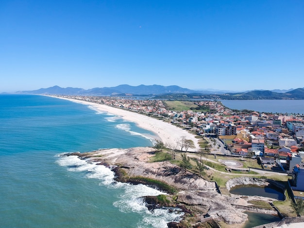 Aerial view of Saquarema and ItaÃÂºna beach in Rio de Janeiro. Famous for the waves and the church on top of the hill. Sunny day. drone photo.