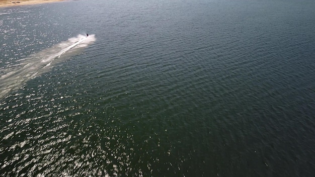 Aerial view of a scooter at the lake surface Luxury floating boat on water at sunny day