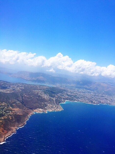 Aerial view of sea against blue sky