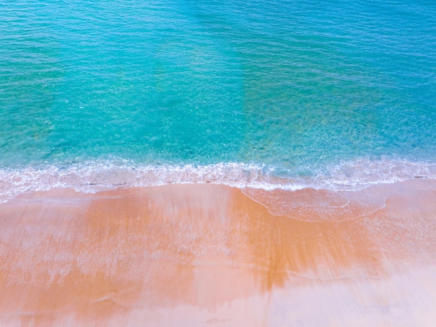 Aerial view of sea crashing waves White foaming waves on beach sandTop view beach sea surface Nature sea beach sand background