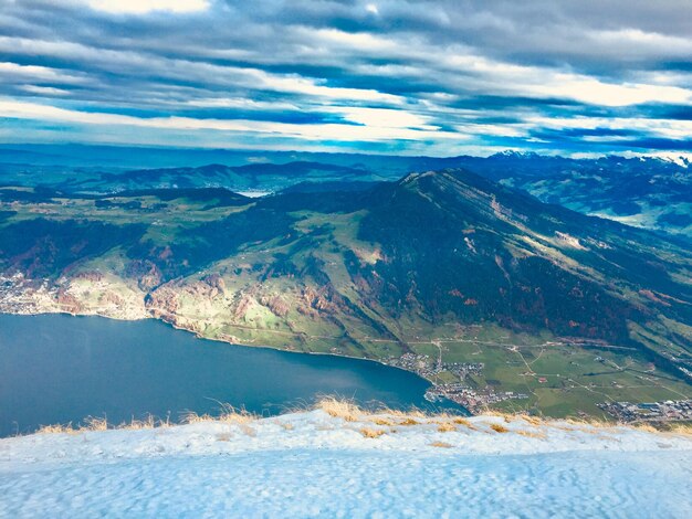 Aerial view of sea and mountains against sky