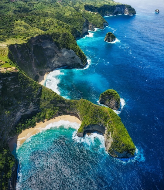 Aerial view at the sea and rocks Blue water background from top view Summer seascape from air Kelingking beach Nusa Penida Bali Indonesia Travel image