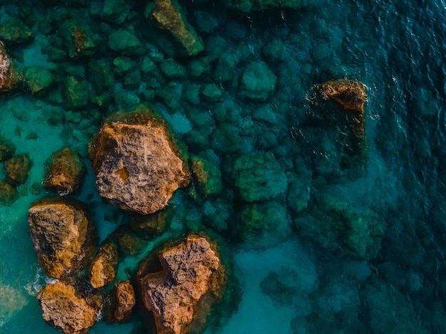 Aerial view of sea rocky beach clear azure water