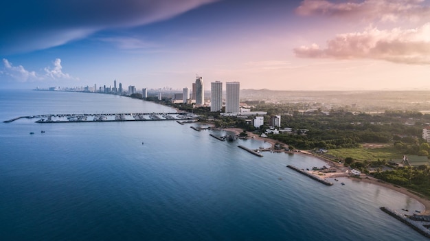 Aerial view of seascape against blue sky in city