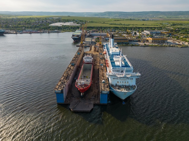 Aerial view shipyard dry dock maintenance and repair cargo ship transport and oil ships in sea