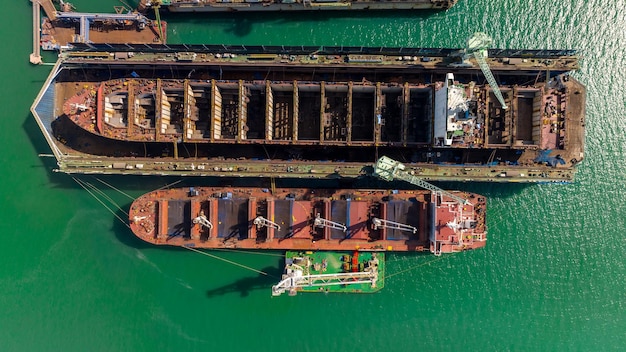 Aerial view shipyard dry dock maintenance and repair container ship transport and oil ships in sea