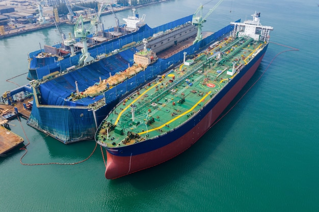 Aerial view of a shipyard repairing a large ship oil tank on the sea Thailand 

