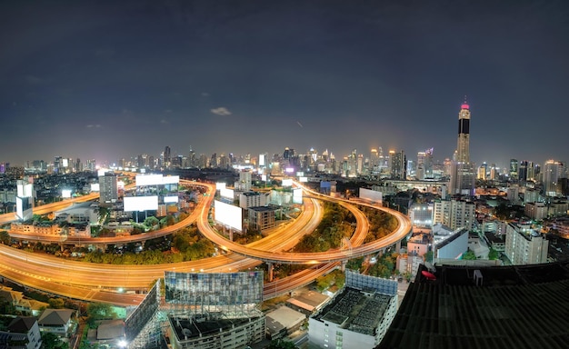 Aerial view skyscraper building with traffic glowing on elevated road