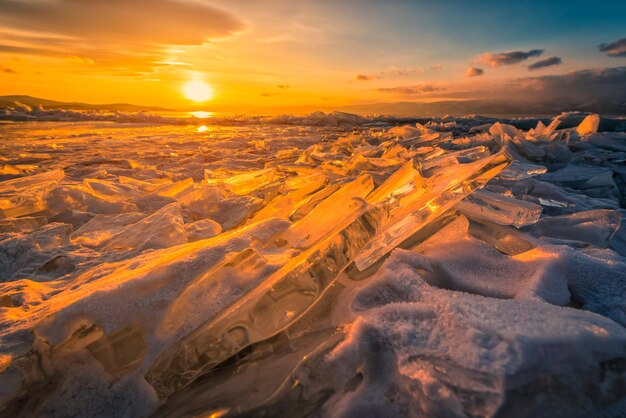 Aerial view of snow covered land during sunset