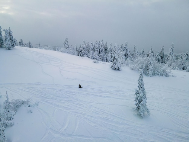 Aerial view of snowboarder free rider at the ski slope winter extreme sport