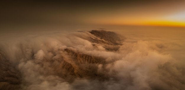 Photo aerial view of snowcapped mountains against sky during sunset