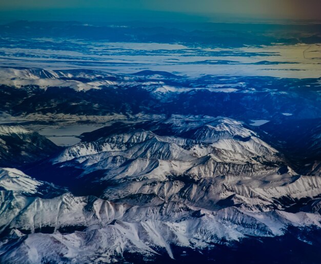 Aerial view of snowcapped mountains against sky