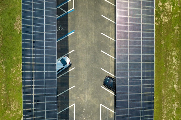 Aerial view of solar panels installed as shade roof over\
parking lot for parked cars for effective generation of clean\
electricity photovoltaic technology integrated in urban\
infrastructure