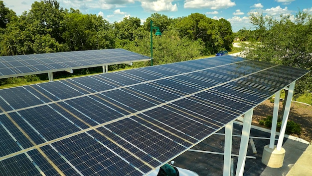 Aerial view of solar panels installed as shade roof over parking lot for parked cars for effective generation of clean electricity Photovoltaic technology integrated in urban infrastructure