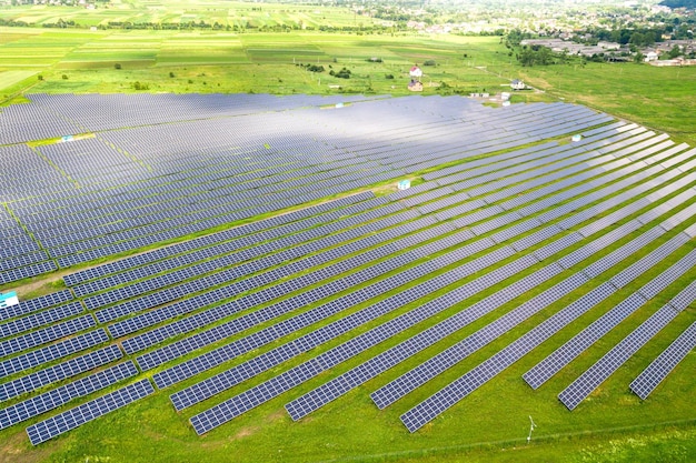 Aerial view of solar power plant on green field Electric panels for producing clean ecologic energy