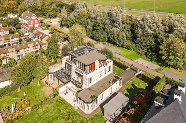 An aerial view of some houses in the country side with trees and green grass on either side of the