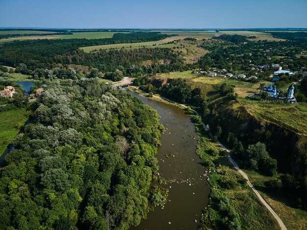 Aerial view of Southern Bug river and granite mountains summer landscape