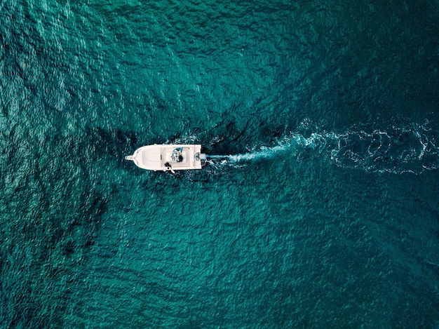 Aerial view of speed boat in motion in blue sea in Italy Water transportation and summer leisure time activity