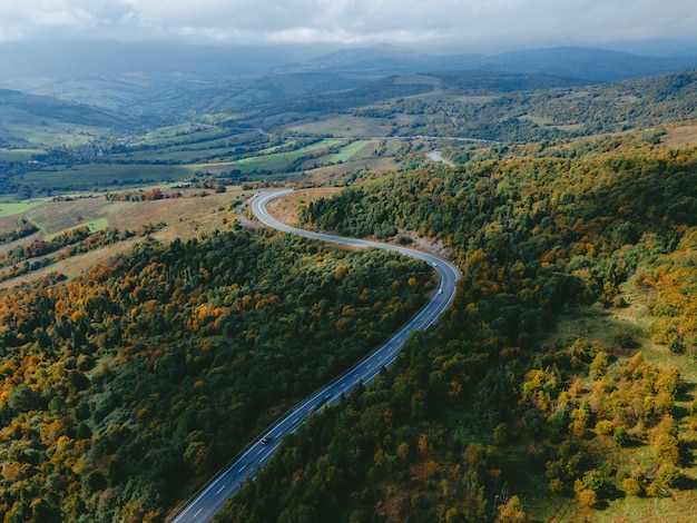 Aerial view of speedway road in autumn carpathian mountains ukraine