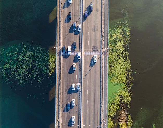 Aerial view of the stream of cars on the bridge