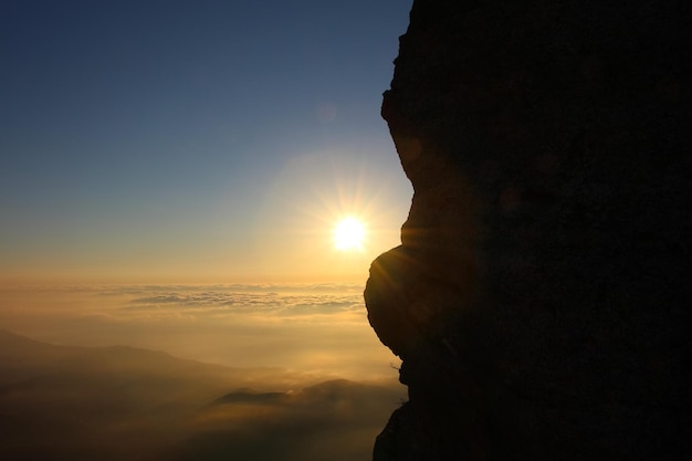 Aerial view of sunrise in the mountains Orange reflex on sky and clouds over sea and valley