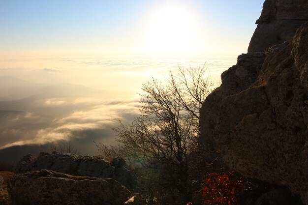 aerial view of sunrise in the mountains with orange reflex on sky clouds over sea rocks and valley