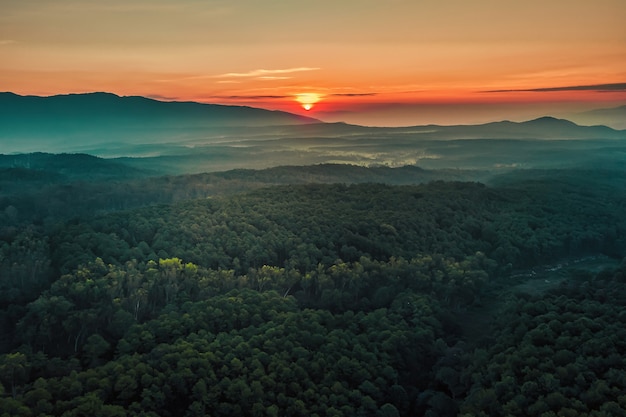 Aerial view of sunrise over mountian and pine tree in Chiang Mai Province, Thailand.