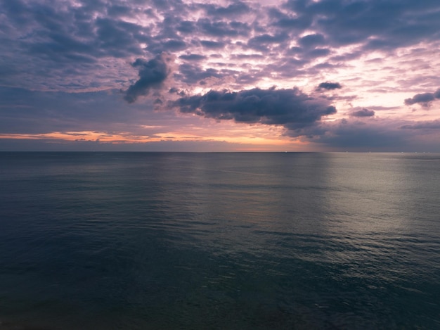 Aerial view sunset sky Nature beautiful Light Sunset or sunrise over dark sea Colorful dramatic majestic scenery Sky with Amazing clouds and waves in sunset sky purple light cloud background