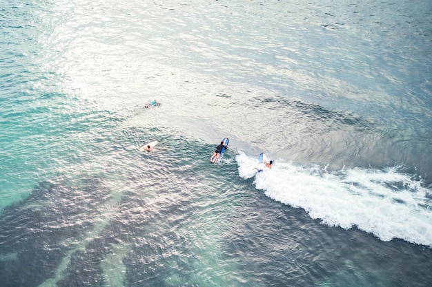 Aerial view of surfers riding waves in the ocean