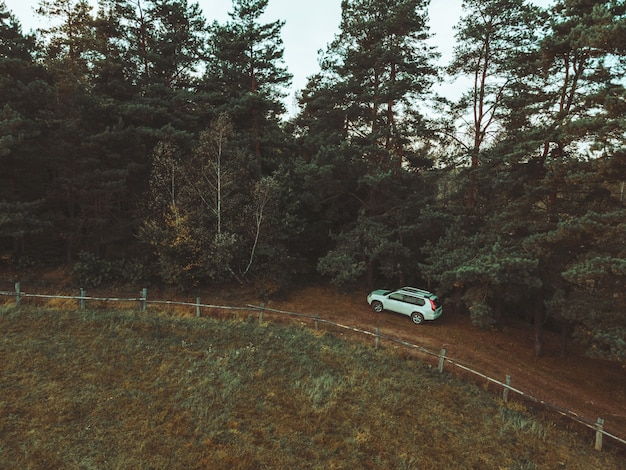 Aerial view of suv car near farm fence