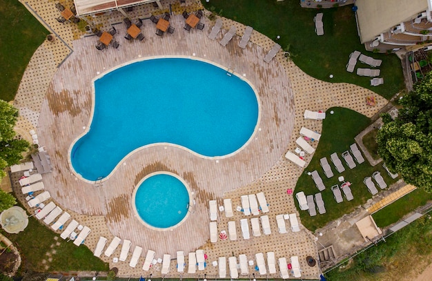 Aerial view of swimming pool with sunbeds at hotel