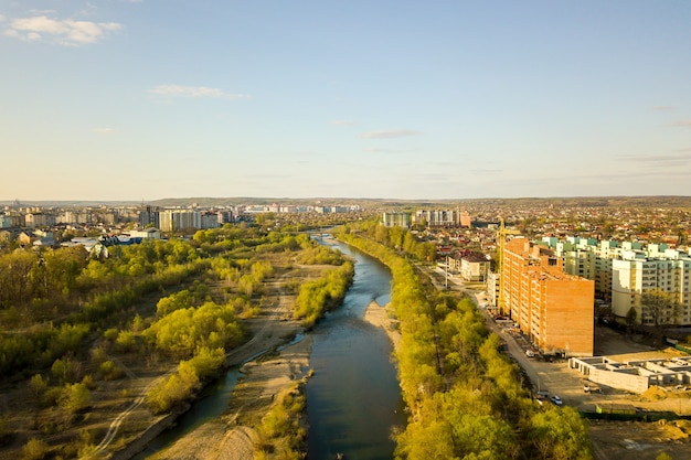 Aerial view of tall residential apartment buildings under construction and Bystrytsia river in Ivano-Frankivsk city, Ukraine.