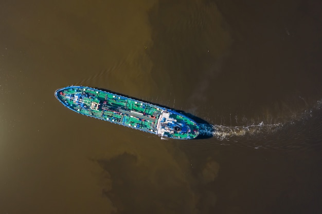 Aerial view of tanker ship sailing on river.