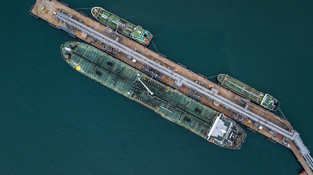 Aerial view tanker ship vessel unloading at port global\
business logistic import export oil and gas petrochemical with\
tanker ship transportation oil from dock refinery