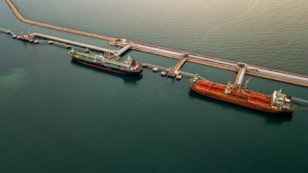 Aerial view tanker ship vessel unloading at port Global business logistic import export oil and gas petrochemical with tanker ship transportation oil from dock refinery