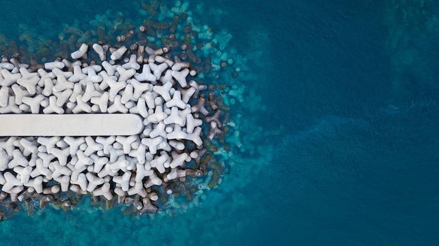 Aerial view of tetrapods by sea