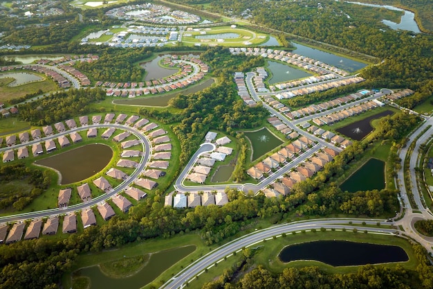 Aerial view of tightly located family houses in Florida closed suburban area Real estate development in american suburbs