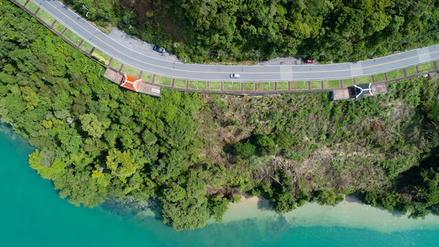 カオカッドビューポイントでプーケット島周辺の道路カーブを上から見下ろす空撮美しい海と山の森の木々