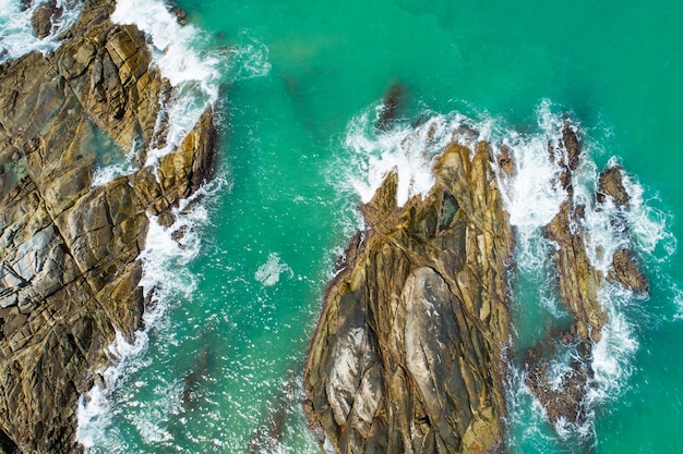 Aerial view Top down seashore wave crashing on seashore Beautiful turquoise sea surface in sunny day Good weather day summer background.