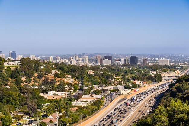 Aerial view towards the skyline of westwood neighborhood highway 405 with heavy traffic in the foreground los angeles california