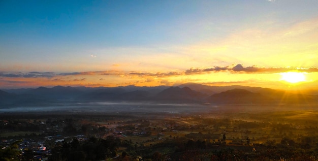 Aerial view of townscape against sky during sunset