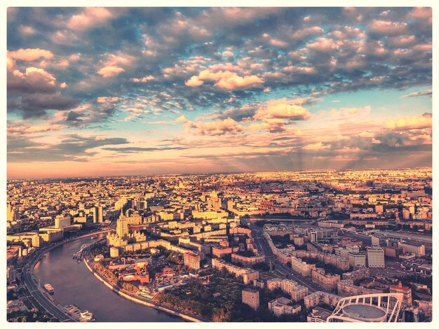 Photo aerial view of townscape against sky during sunset