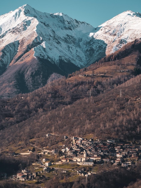 Aerial view of townscape by mountain against sky