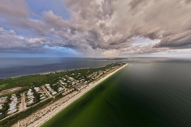 Aerial view of tropical storm over rich neighborhood with expensive vacation homes in Boca Grande small town on Gasparilla Island in southwest Florida