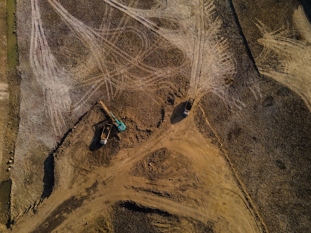 aerial view of  truck and excavator or backhoe working in the construction site