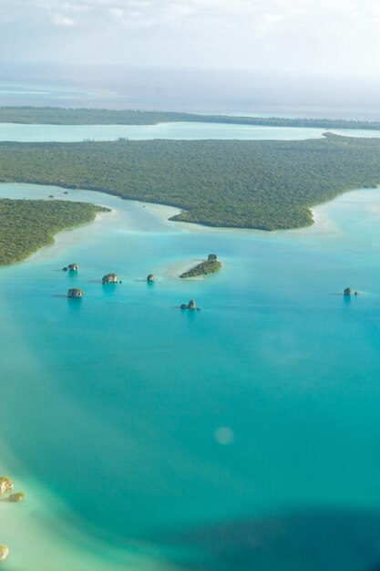 Aerial view of upi bay isle of pines a tropical island off the coast of new caledonia sea is turquoise