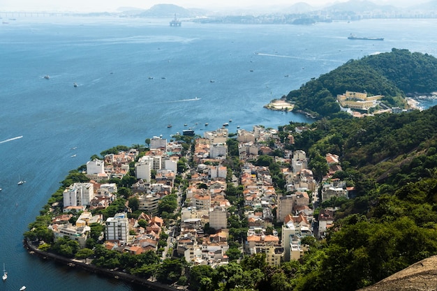 Aerial view of the Urca neighborhood in Rio de Janeiro Brazil with its old buildings Surrounded by boats in Guanabara Bay and a landscape full of trees and hills