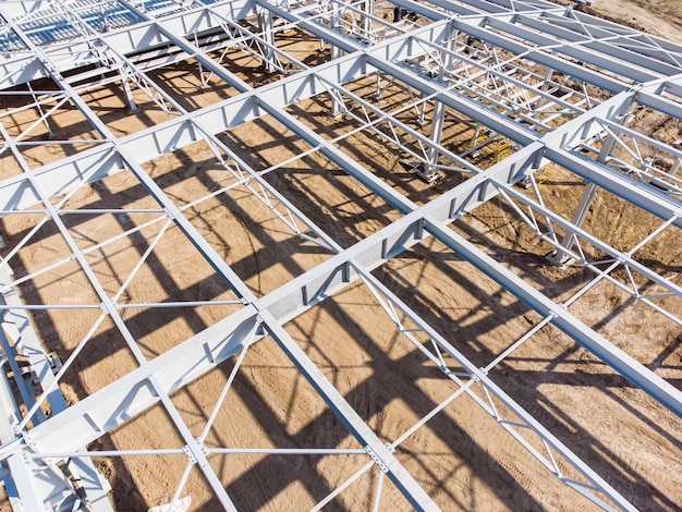 Aerial view of warehouse construction from steel metal structure Frame of modern hangar or factory construction site