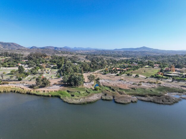 Aerial view over water reservoir and a large dam that holds water rancho santa fe in san diego